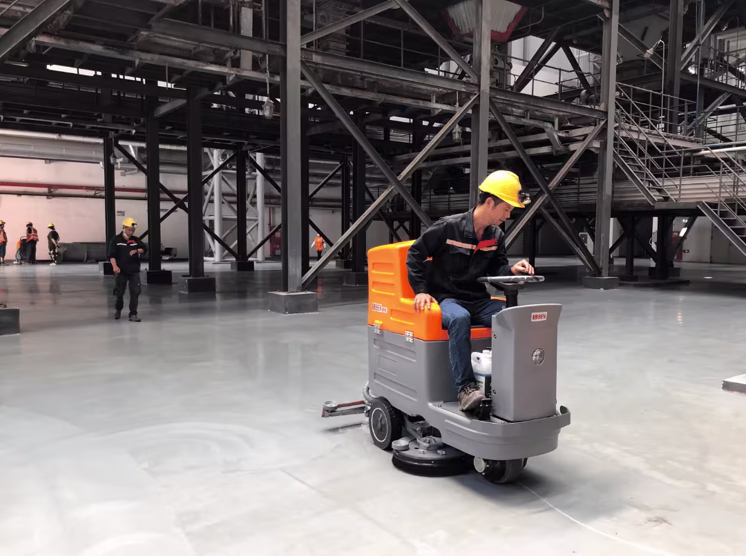 Ride on floor scrubber in warehouse